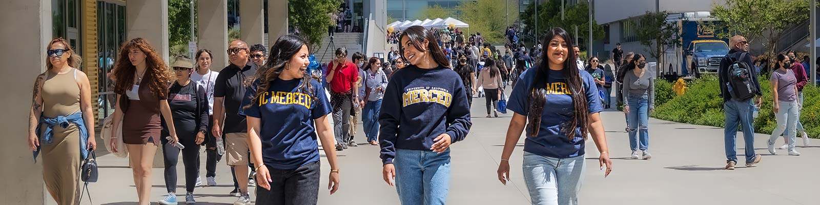 students walking through campus laughing and enjoying life